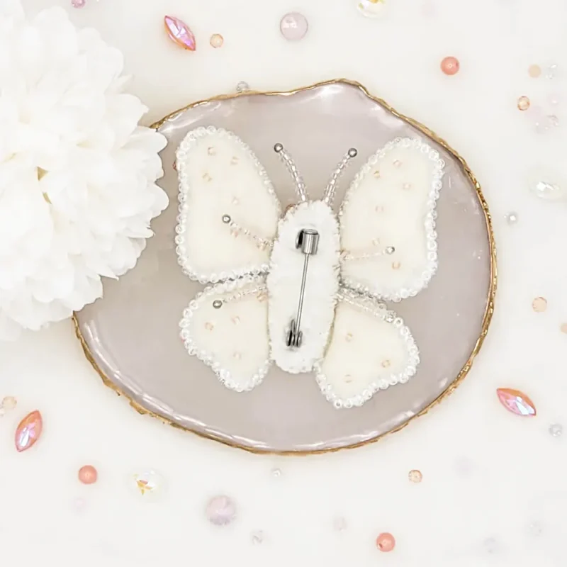 Handmade butterfly brooch pin by Fae Fancies, in ivory and peach color, Dreamy collection, silk velvet, hand-embroidery, back side