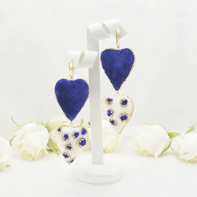 Handmade beaded heart earrings by Fae Fancies in blue and ivory color, animal print, silk velvet, Flirty Collection, display showcase