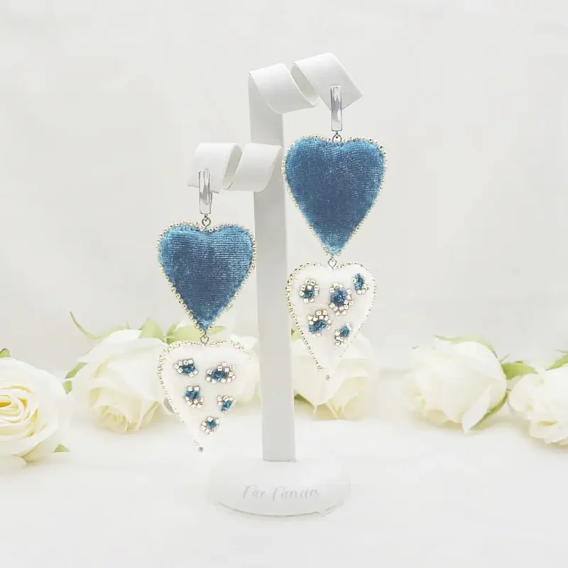 Handmade beaded heart earrings by Fae Fancies in teal and ivory color, animal print, silk velvet, Flirty Collection, display showcase