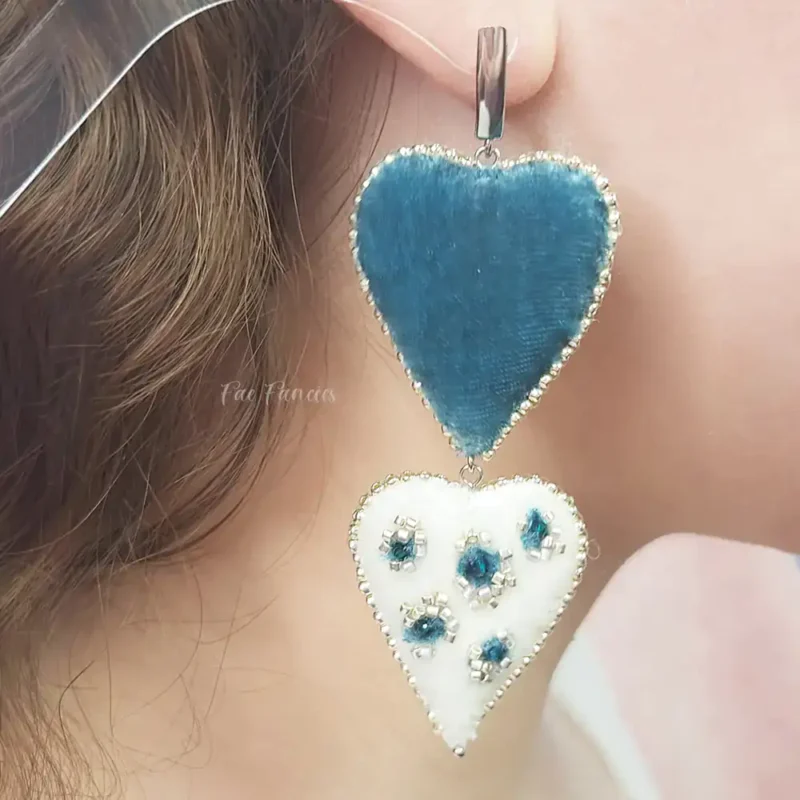 Handmade beaded heart earrings by Fae Fancies in teal and ivory color, animal print, silk velvet, Flirty Collection, model showcase