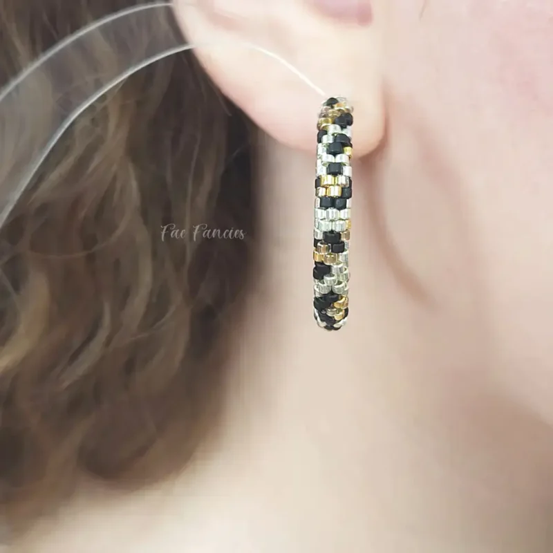 Handmade beaded hoop earrings by Fae Fancies, animal print, seed beads, model showcase