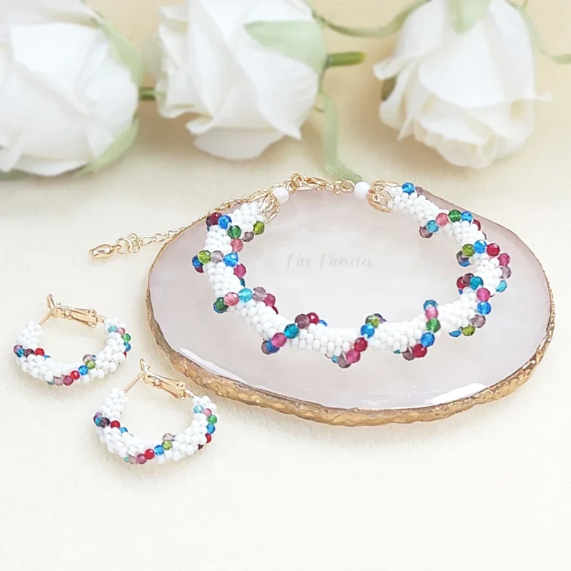 Handmade beaded hoop earrings and bracelet set by Fae Fancies, white color with multicolored glass beads weaved around, Spiral Collection, main product photo